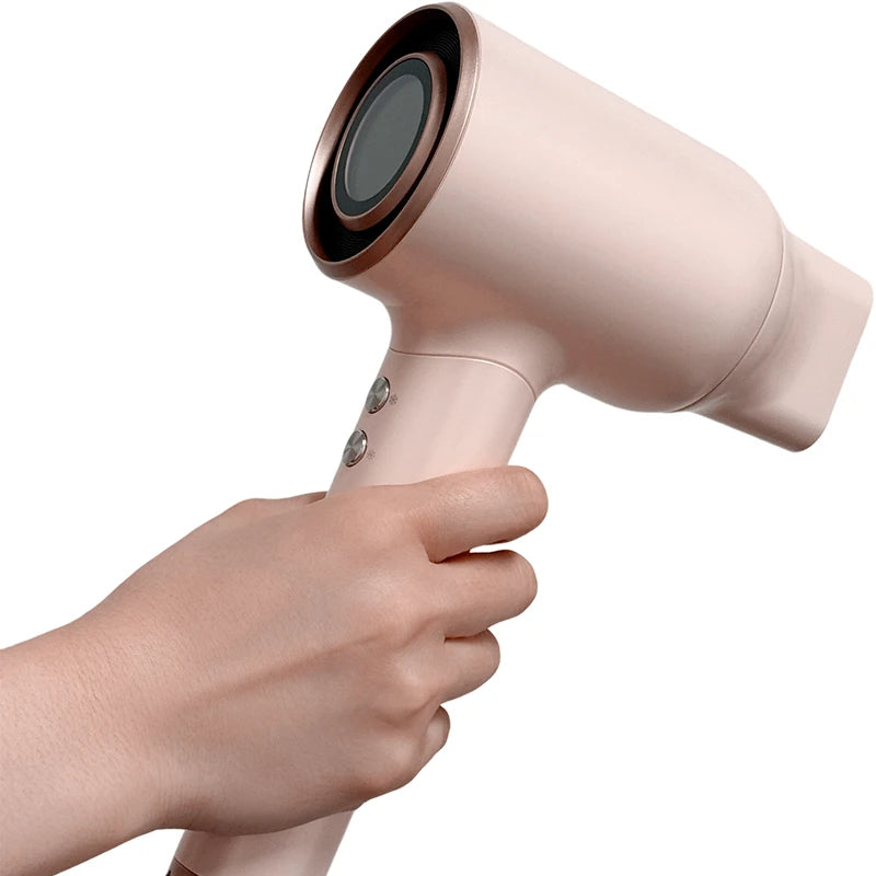 Model holding the Vividreamore Velo IntelliSense hair dryer, showing ergonomic handle design for optimized grip comfort during styling