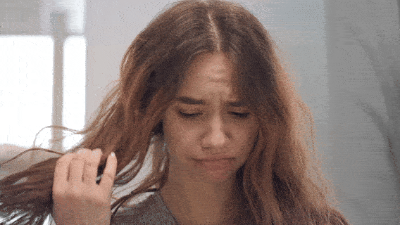 Frustrated woman holding frizzy hair, comparing traditional blow dryer damage vs Vividreamore Velo Essential ionic curly hair dryer with high air volume and comb attachment.