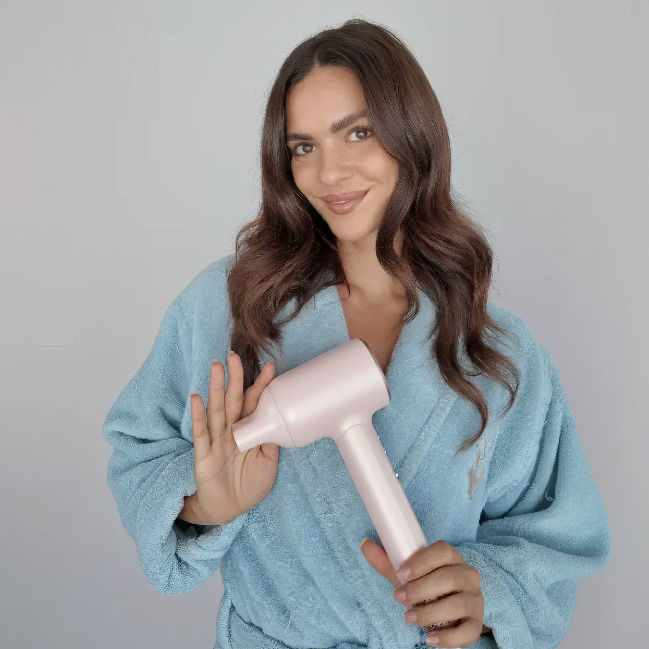 Woman holding the Vividreamore Velo Lite 202 hair dryer, designed with lightweight comfort, negative ion technology, and salon-quality performance for fast drying and everyday styling.