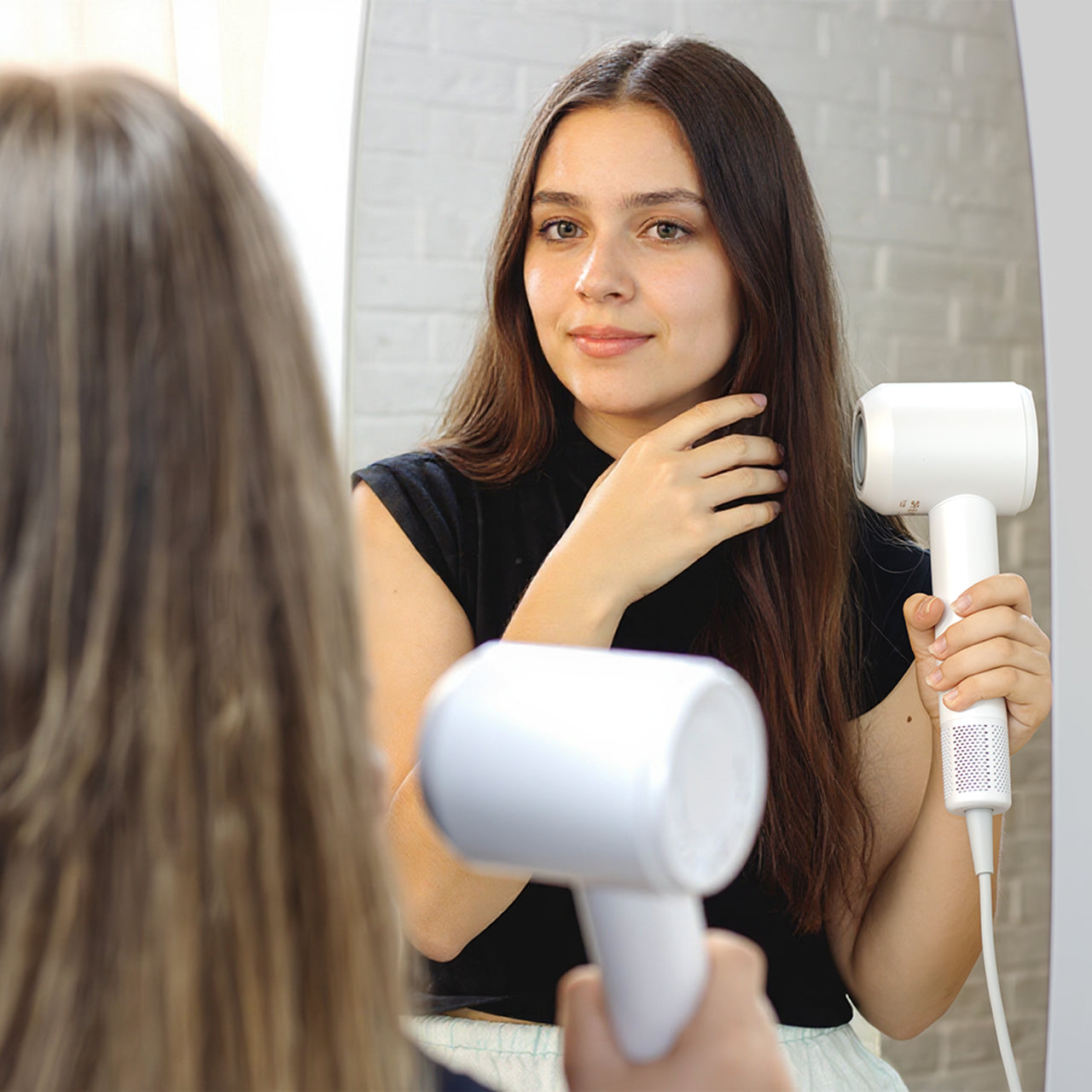Model holding Vividreamore Velo Essential white hair dryer – smart heat control protects color-treated and aging hair
