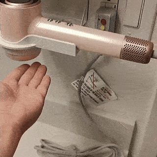 Animated demo of Vividreamore Velo IntelliSense hair dryer in hands-free drying mode, automatically activating airflow to dry hands quickly and effortlessly without bending.